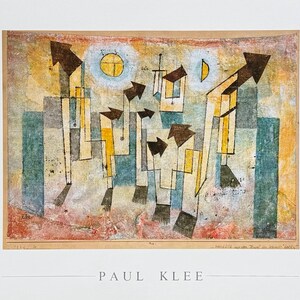 May include: A Paul Klee art print featuring an abstract composition of geometric shapes, dark arrows, and vertical lines in shades of blue, yellow, and red. The artwork includes a yellow sun and crescent moon, with the artist's name printed below.