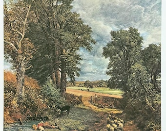 May include: A landscape print featuring a person lying by a small stream near a dirt path. A black and white dog stands on the path, followed by a small flock of white sheep. Tall green trees frame the scene under a cloudy blue sky.