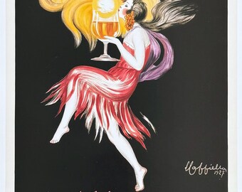 May include: A vintage 1927 poster featuring a figure in a red dress holding a glass of amber liquid against a black background. A large yellow sunburst radiates behind the figure. Text reads: ..du soleil dans un verre.. COGNAC MONNET.