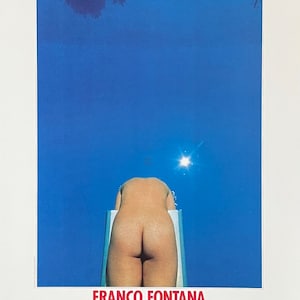 May include: A vintage art poster showing a person diving into a pool against a bright blue sky. The poster includes the text "FRANCO FONTANA AMSTERDAM FOTO 84". The image has a minimalist aesthetic.