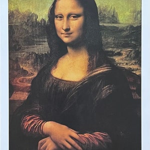May include: A close-up portrait of the Mona Lisa, a famous painting by Leonardo da Vinci. The subject is a woman with dark hair and a soft smile, wearing a dark dress with a red sleeve. The background is a landscape with a hazy, green sky.