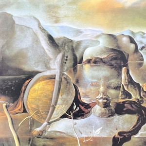 May include: A surrealist painting depicting a nude figure lying on a rocky landscape. A large, golden globe is in the foreground, with a small, white figure standing close by. The painting is full of dreamlike imagery and symbolism.