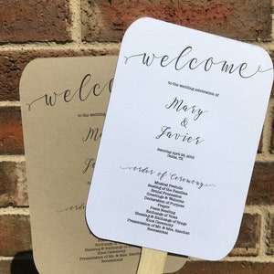 Puede incluir: Dos abanicos blancos de ceremonia de boda con texto en caligrafía negra. El abanico superior dice "Bienvenido a la celebración de la boda de Mary & Javier" y el abanico inferior dice "Orden de la ceremonia" con una lista de eventos.