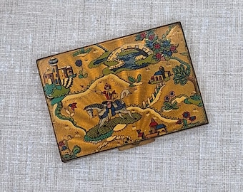 Polvos compactos Vogue Vanitie ~ Diseño 'Las mil y una noches' sobre fondo dorado ~ 1948