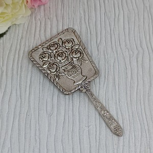 Espejo de mano de metal blanco con rosas repujadas en un jarrón ~ Espejo de tocador pequeño en tono plateado con flores en relieve