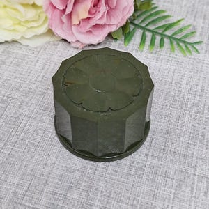 May include: A dark green, octagonal, vintage trinket box with a flower design on the lid.