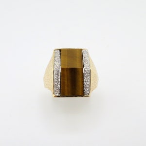 May include: A gold ring with a square tiger's eye stone and diamond accents.
