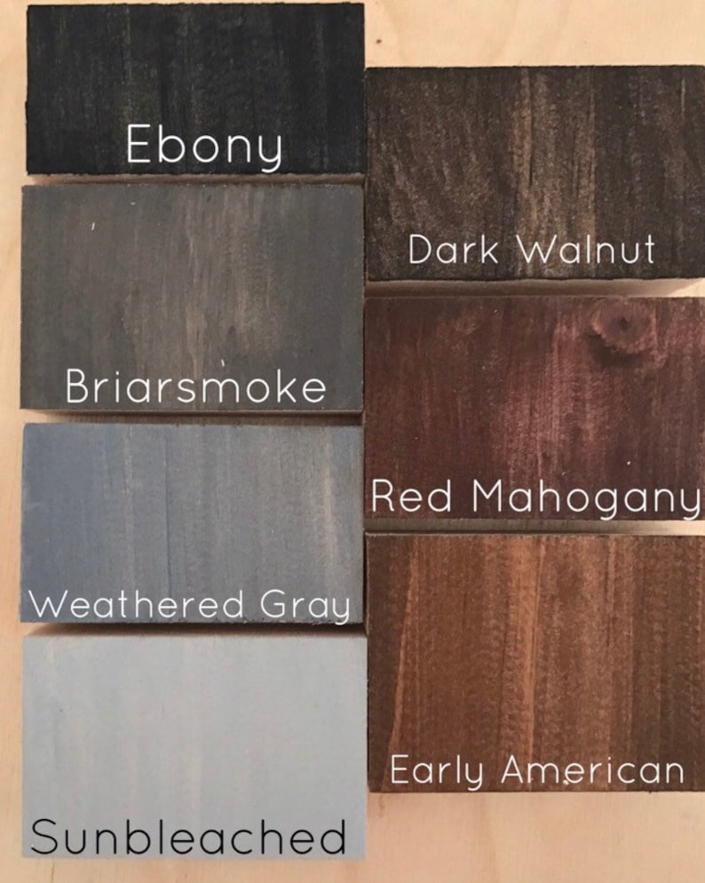 May include: Six wood stain samples in different shades of brown, gray, and black. The samples are labeled with the following names: Ebony, Dark Walnut, Briarsmoke, Red Mahogany, Weathered Gray, and Sunbleached.