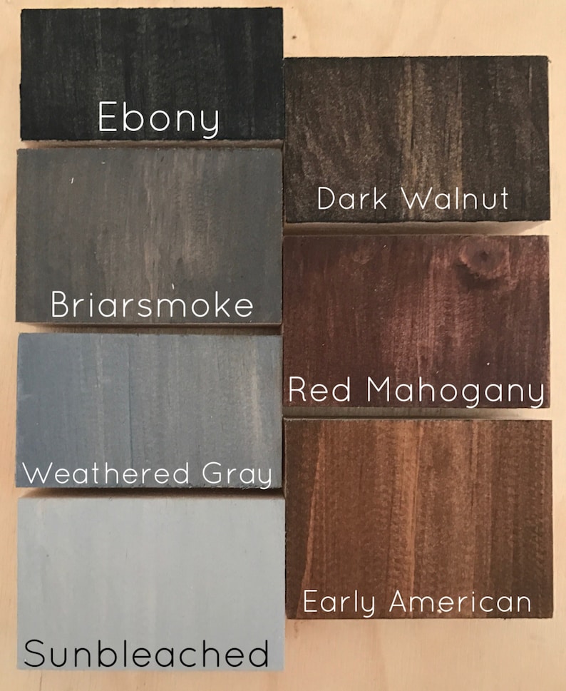May include: Six wood stain samples in different shades of brown, gray, and black. The samples are labeled with the following names: Ebony, Dark Walnut, Briarsmoke, Red Mahogany, Weathered Gray, and Sunbleached.
