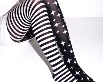 May include: Opaque tights featuring an asymmetrical design. One leg displays horizontal black and white stripes, while the other leg is solid black with a repeating pattern of white four-pointed stars scattered across the entire length.