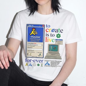 May include: A white short-sleeve t-shirt featuring a graphic print of a vintage computer interface. The design includes an Impulse Instant Messenger sign-on window, a desktop computer illustration, and the text to create is to live for-ever.