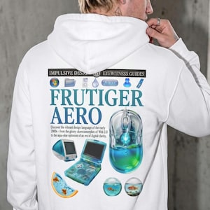 May include: A white hoodie featuring a graphic print on the back with the text "IMPULSIVE DESIGN" and "FRUTIGER AERO". The design includes early 2000s digital icons, a translucent computer mouse, a handheld game console, and goldfish in bowls.