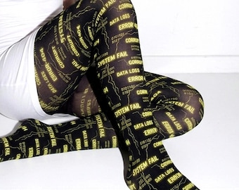 May include: Black tights featuring a repeating yellow graphic print of computer-themed text including "SYSTEM FAIL," "DATA LOSS," "ERROR," and "CORRUPT," interspersed with thin, jagged white lines resembling digital circuit patterns.