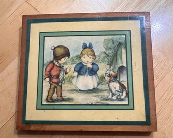 Small wall hanging on wood of kids with dog
