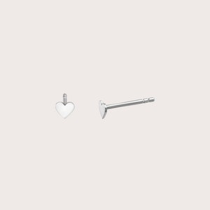 May include: A pair of silver heart-shaped stud earrings. The earrings are small and delicate, and they have a simple, elegant design.