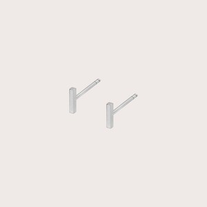May include: A pair of silver bar stud earrings. The earrings are simple and minimalist, with a straight bar design.