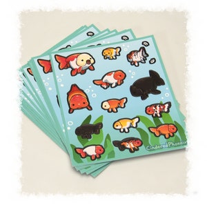 May include: A stack of stickers featuring various goldfish and black fish illustrations on a blue background with white bubbles. The stickers are on a light blue background with the text "CinderedPhoenix" in the bottom right corner.