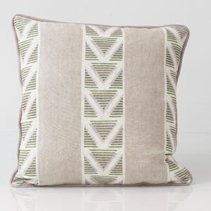 May include: Square decorative pillow with a geometric pattern. The pillow features a light beige background with vertical stripes and a repeating pattern of green and white triangles. The edges are trimmed with a gray border.