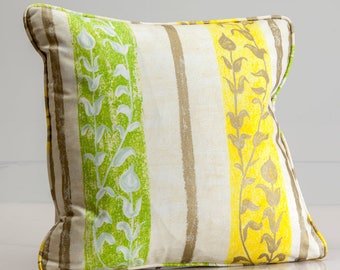 May include: A striped throw pillow with a floral pattern in shades of green and yellow. The pillow is made of a soft, textured fabric.