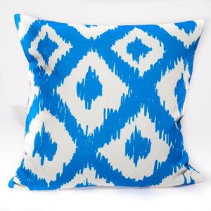 May include: A blue and white patterned throw pillow with a geometric design. The pillow is made of a soft, comfortable fabric and is perfect for adding a touch of style to any room.