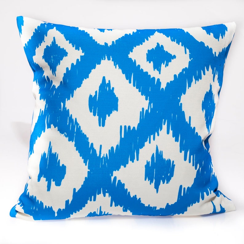 May include: A blue and white patterned throw pillow with a geometric design. The pillow is made of a soft, comfortable fabric and is perfect for adding a touch of style to any room.