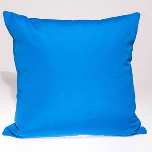 May include: A bright blue pillow with a smooth, soft fabric surface. The pillow is rectangular and has a simple, classic design.