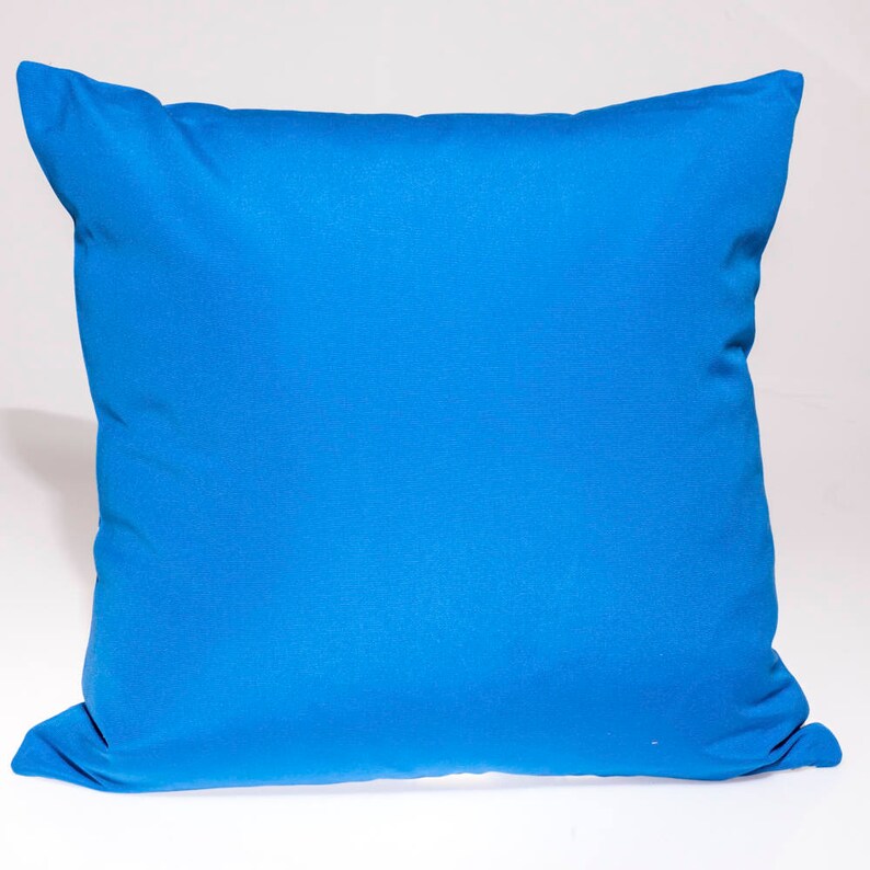 May include: A bright blue pillow with a smooth, soft fabric surface. The pillow is rectangular and has a simple, classic design.
