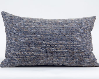 May include: A blue and beige striped throw pillow with a soft, textured fabric.