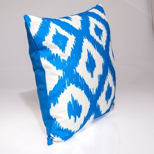 May include: A blue and white patterned throw pillow with a geometric design. The pillow is made of a soft, comfortable fabric and is perfect for adding a touch of style to any room.