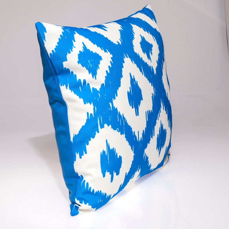 May include: A blue and white patterned throw pillow with a geometric design. The pillow is made of a soft, comfortable fabric and is perfect for adding a touch of style to any room.