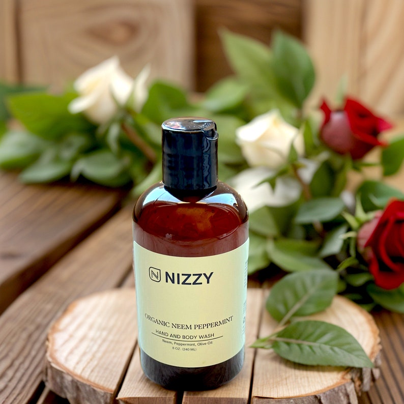 May include: A brown bottle of organic neem peppermint hand and body wash with a white label that says "NIZZY" and "ORGANIC NEEM PEPPERMINT HAND AND BODY WASH Neem, Peppermint, Olive Oil 8 fl. oz. (240 mL)".