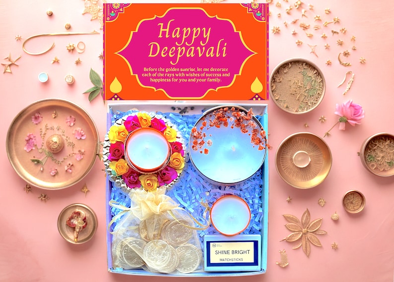 A Diwali gift box open with various items inside