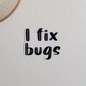 May include: White sticker with black text that reads "I fix bugs".