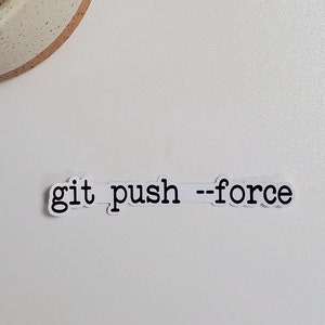 May include: A white background with a small potted cactus in the top left corner. The text "git push --force" is written on a white sticker in the bottom center of the image.