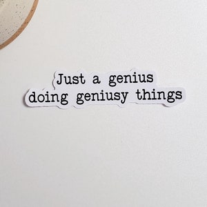 May include: White sticker with black text that reads "Just a genius doing geniusy things".