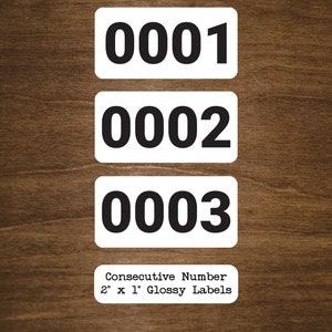 May include: Three white labels with black numbers 0001, 0002, and 0003. The labels are 2 inches by 1 inch and are described as "Consecutive Number 2" x 1" Glossy Labels".