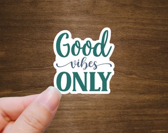 May include: A white sticker with a green and blue design. The sticker says "Good vibes ONLY".
