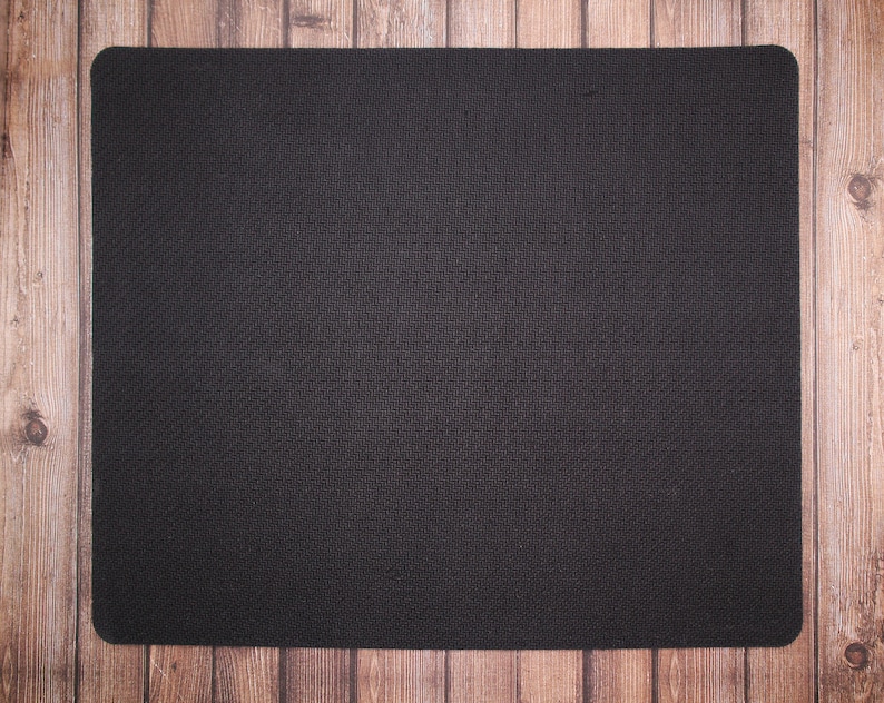 May include: A black mouse pad with a textured surface.