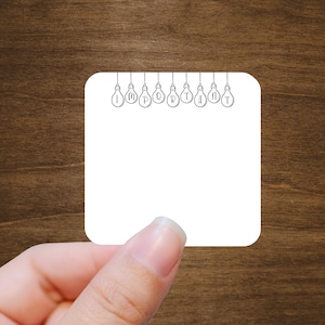 May include: A white card with the word "IMPORTANT" spelled out using light bulbs. The card is held by a hand against a brown wooden background.