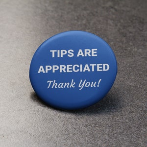 May include: A round, blue button with white text that reads "TIPS ARE APPRECIATED Thank You!". The button is centered on a gray, textured surface.