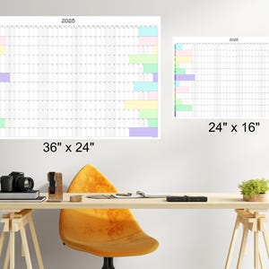 May include: Two white dry-erase calendars with colorful stripes on the side. The larger calendar is 36 inches by 24 inches and the smaller calendar is 24 inches by 16 inches. Both calendars are labeled with the year 2025.