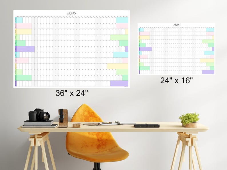 May include: Two white dry-erase calendars with colorful stripes on the side. The larger calendar is 36 inches by 24 inches and the smaller calendar is 24 inches by 16 inches. Both calendars are labeled with the year 2025.