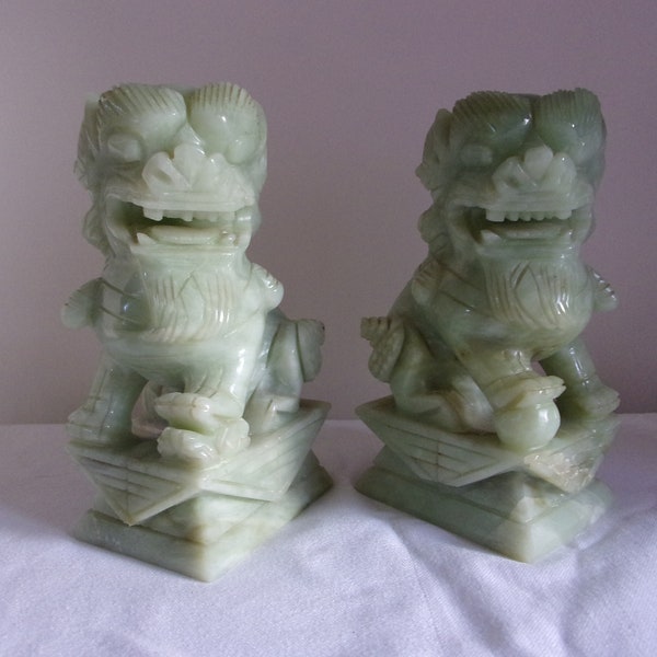 Chinese Foo Dogs Pair of heavy carved pale green jade or stone