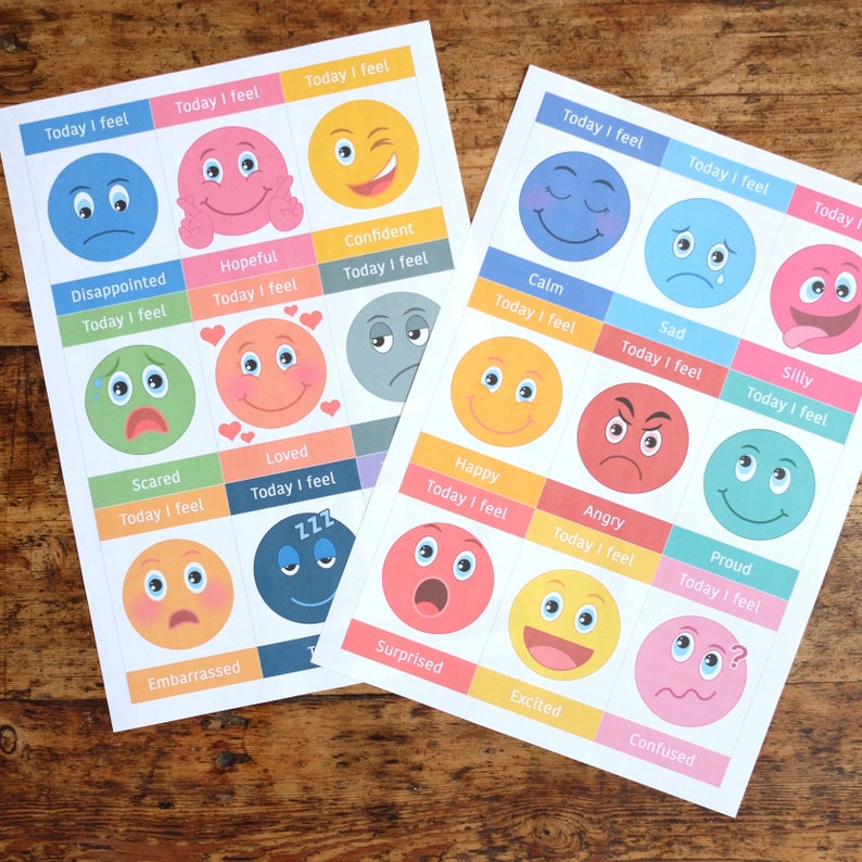 May include: Three sheets of paper with colourful cartoon faces and the text "Today I feel" above each face. The faces represent different emotions, such as happy, sad, angry, scared, and confused.