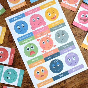 May include: A printable worksheet with colourful cartoon faces representing different emotions. Each face has a text box with the phrase "Today I feel" and a word describing the emotion. The emotions include: excited, angry, proud, embarrassed, disappointed, hopeful, confident, scared, loved, bored, tired, worried, silly.