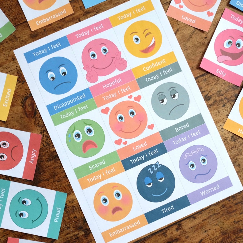 May include: A printable worksheet with colourful cartoon faces representing different emotions. Each face has a text box with the phrase "Today I feel" and a word describing the emotion. The emotions include: excited, angry, proud, embarrassed, disappointed, hopeful, confident, scared, loved, bored, tired, worried, silly.