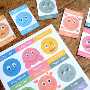 May include: A set of colourful cards with different emotions, each card has a cartoon face and the text "Today I feel" followed by the emotion word. The emotions include: sad, bored, loved, confident, hopeful, disappointed, silly.