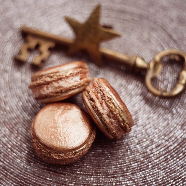 Traditional french gold macarons Pastry and bakery with branding concept Parisian chic dessert Copy space, Close up Holiday Backdrop Design