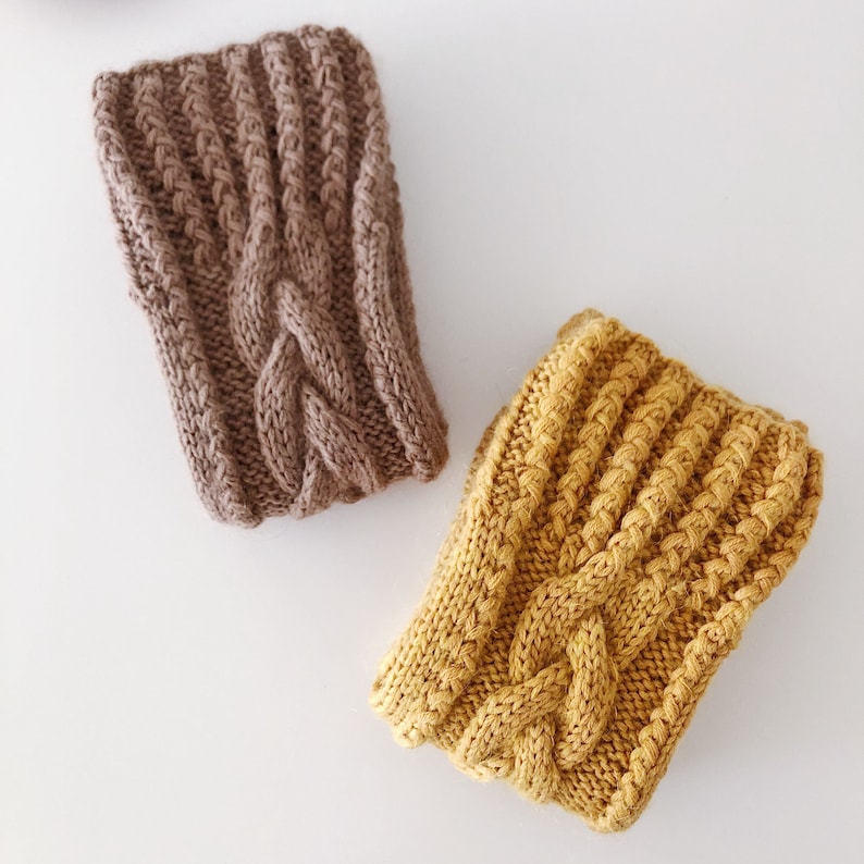 May include: Two knitted cable knit headbands in brown and mustard yellow.