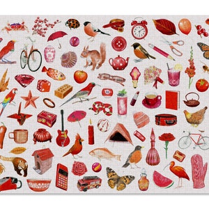 May include: A completed jigsaw puzzle with a collage of watercolour illustrations in red, orange, and pink. The puzzle features images of a strawberry, birds, a bicycle, a guitar, and a robot.